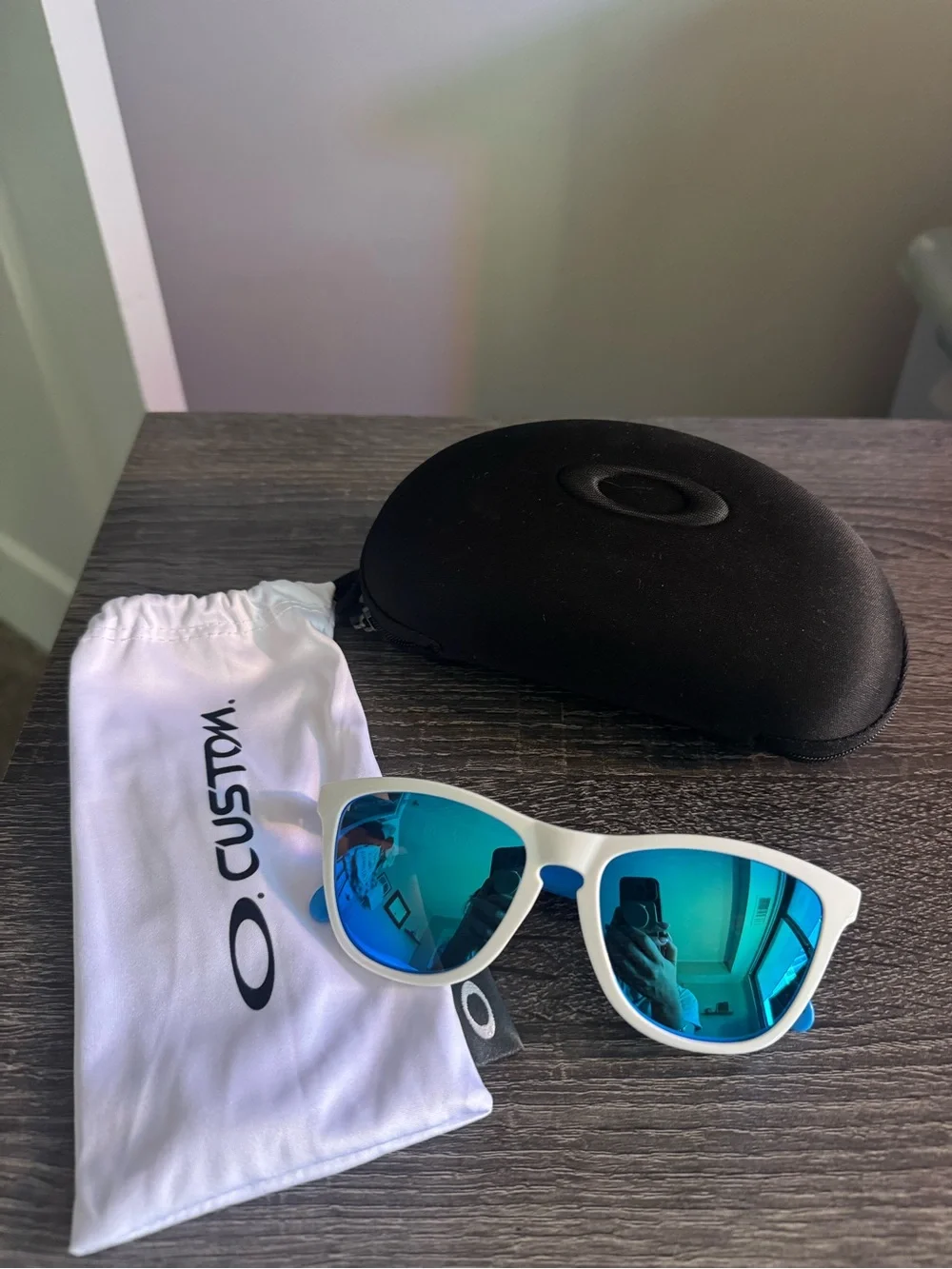 Oakley White Frame Sunglasses with Blue Mirrored Lenses